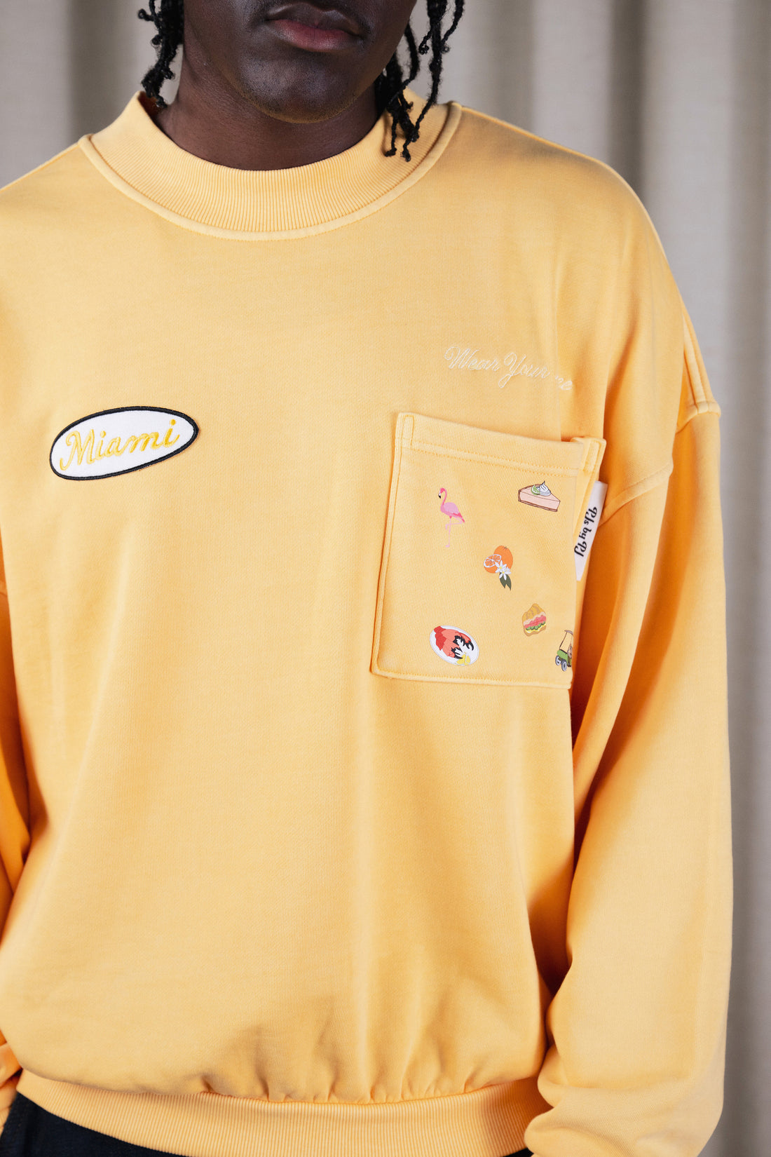 Miami Crewneck in Sunshine Yellow — pocket detail